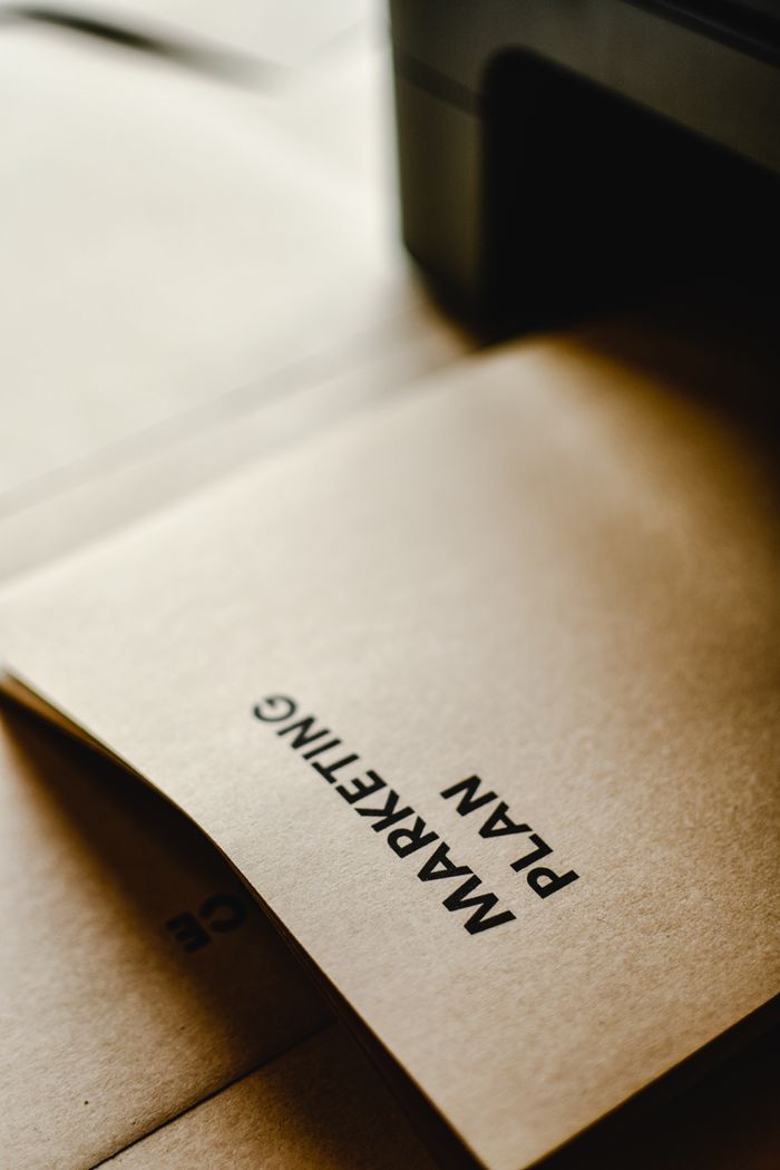 services-01 Detailed view of the words Marketing Plan printed on brown paper, conceptual and business themed.